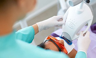 Man receiving teeth whitening treatment