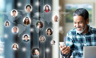 a man smiling while connecting with people online