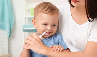 helping baby brush