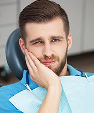 Man holding jaw in dental chair