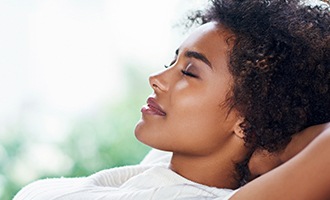 Relaxing woman with hands behind head