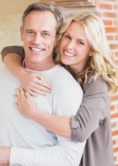 Smiling man and woman outdoors