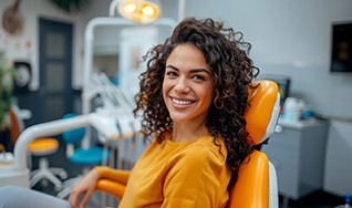 Happy woman in dental treatment chair