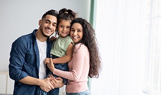 Portrait of happy parents with their little girl
