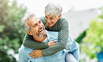 Couple smiling with dentures in Westminster 