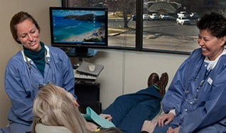 Dr. Bancroft patient and assistant laughing with patient