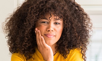 Woman holding jaw in pain