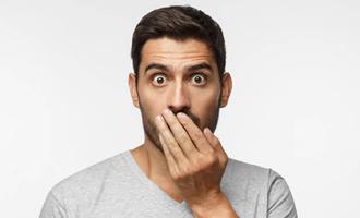 man covering mouth