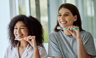  a couple brushing their teeth