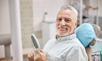 Man with dental implants in Westminster