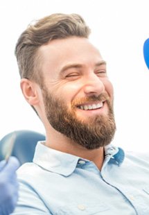 patient smiling in dental mirror 