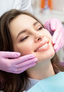 patient smiling while looking in dental mirror 