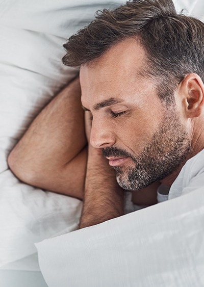 Man sleeping soundly in bed