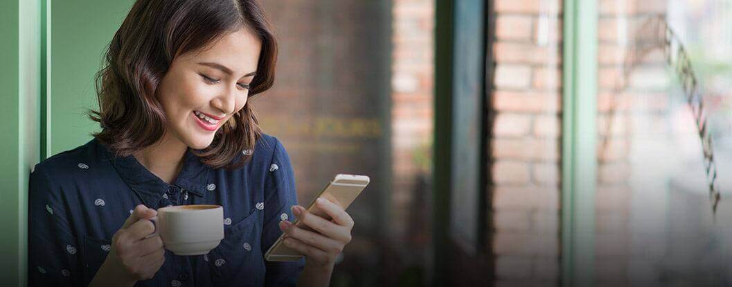 Smiling woman looking at cellphone