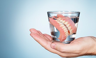 Glass of water with dentures