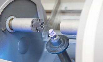 An up-close view of a same-day crown being created in the milling unit