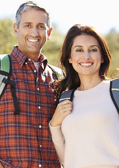 Smiling man and woman outdoors