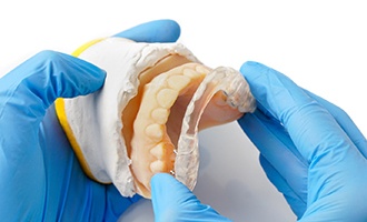 Dentist adjusting occlusal splint in Westminster