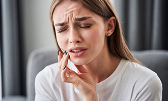 Woman experiencing jaw pain in Westminster