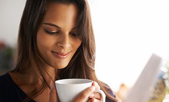 Woman holding cup of coffee