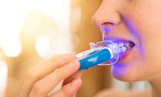 a person using an at-home teeth whitening kit