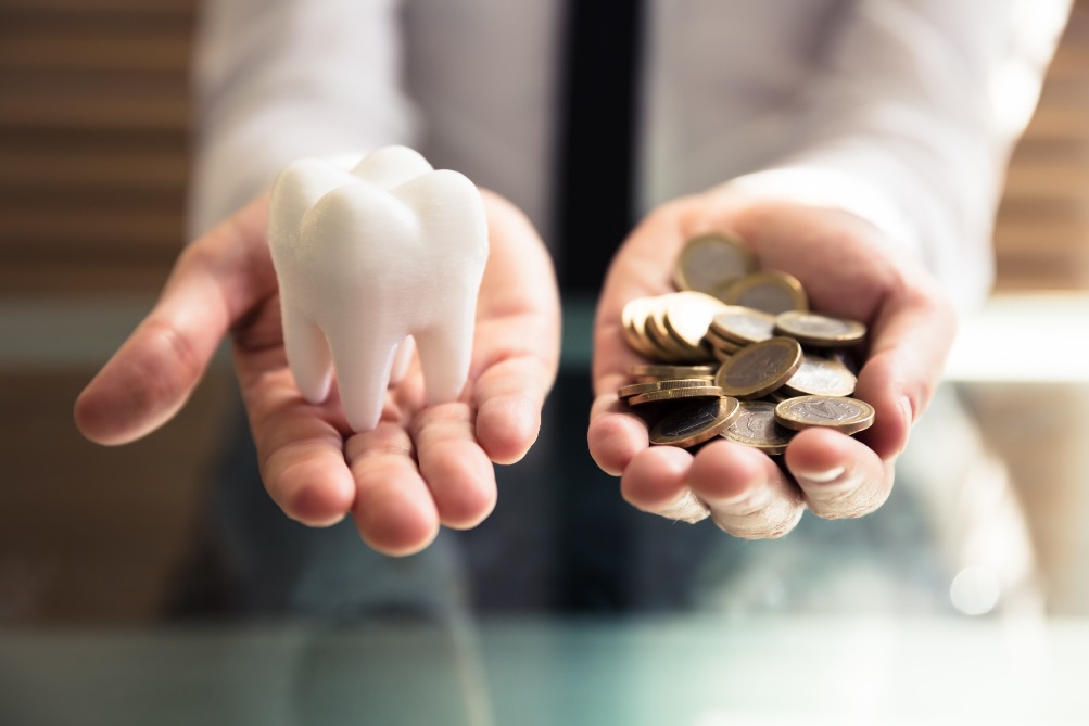 Tooth in one hand, coins in the other