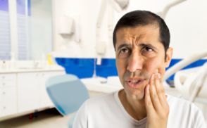 Distressed man in pain before seeing an emergency dentist