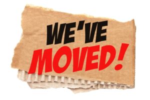 “We’ve Moved” in bold lettering on piece of cardboard