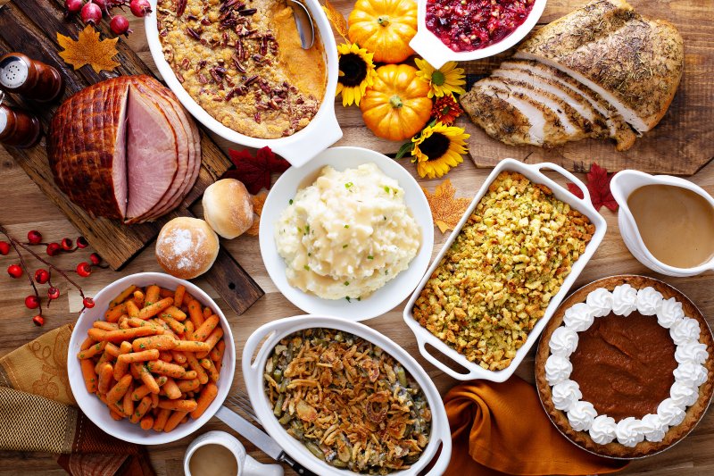 a table full of Thanksgiving side dishes