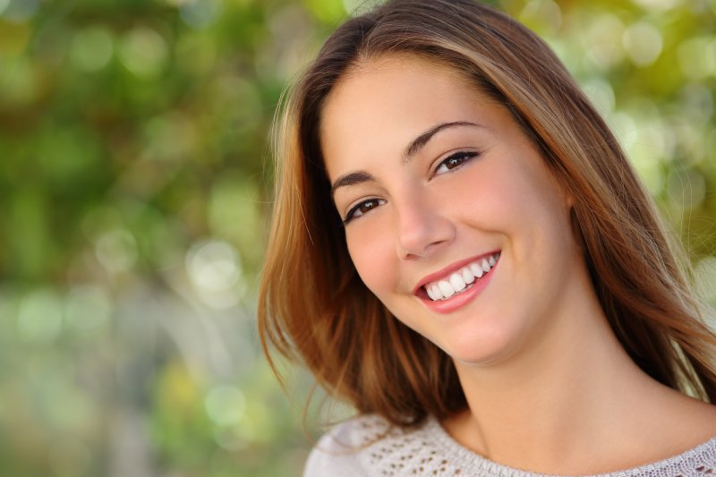 a young female smiling after learning how to get whiter teeth in Westminster