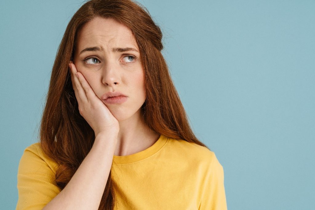 Patient with red hair experiencing a toothache