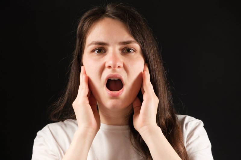 woman performing jaw exercises