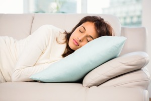 Woman lying on couch taking a nap